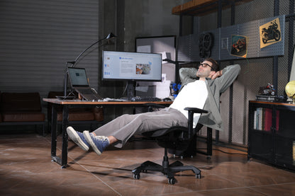 Picture showing a TGIF Ace Home black with a person sitting on it and relaxing