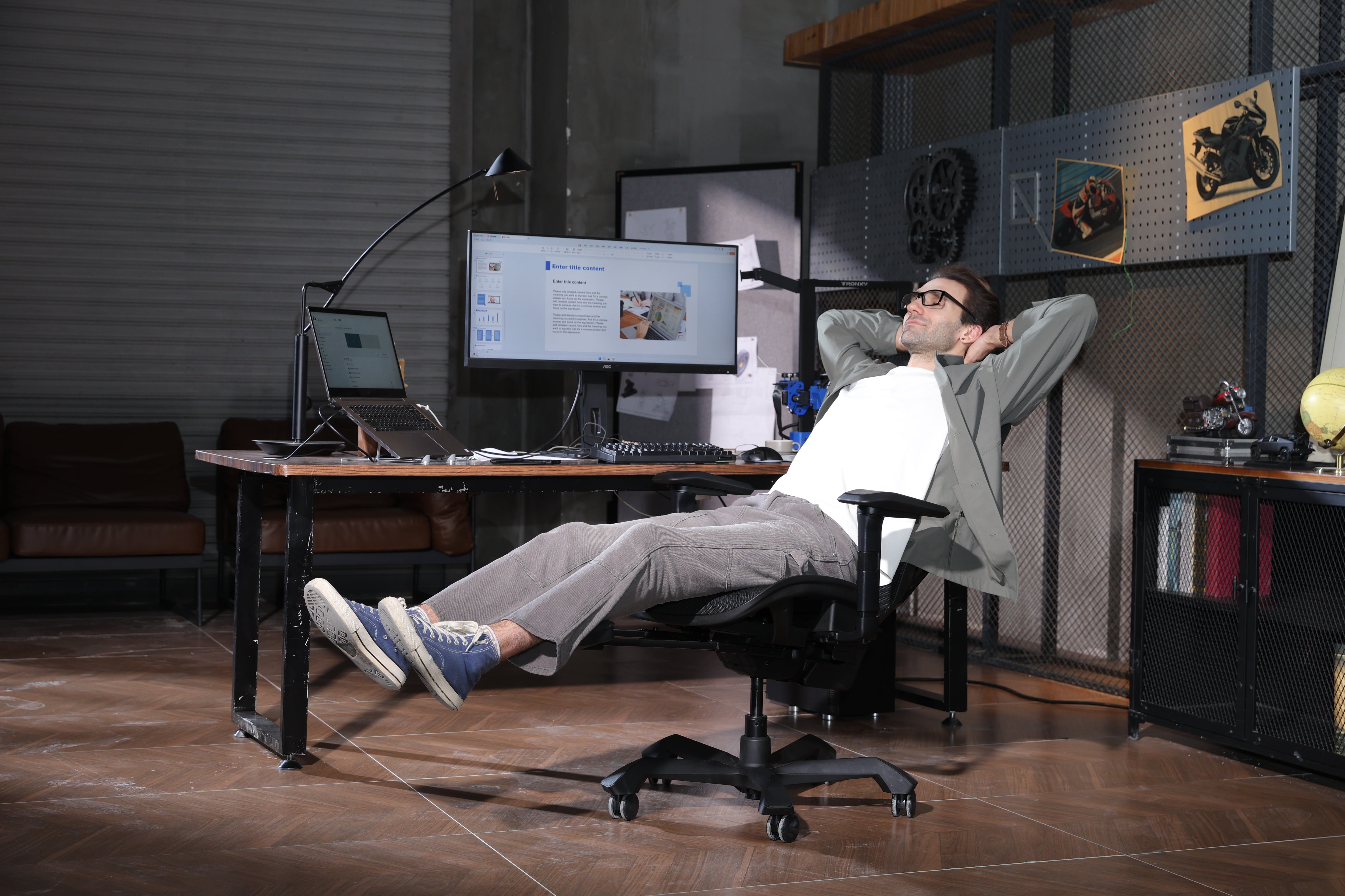 Picture showing a TGIF Ace Home black with a person sitting on it and relaxing
