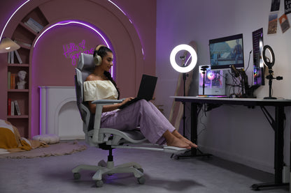 Picture showing a person working on her laptop and sitting on a TGIF Ace home white