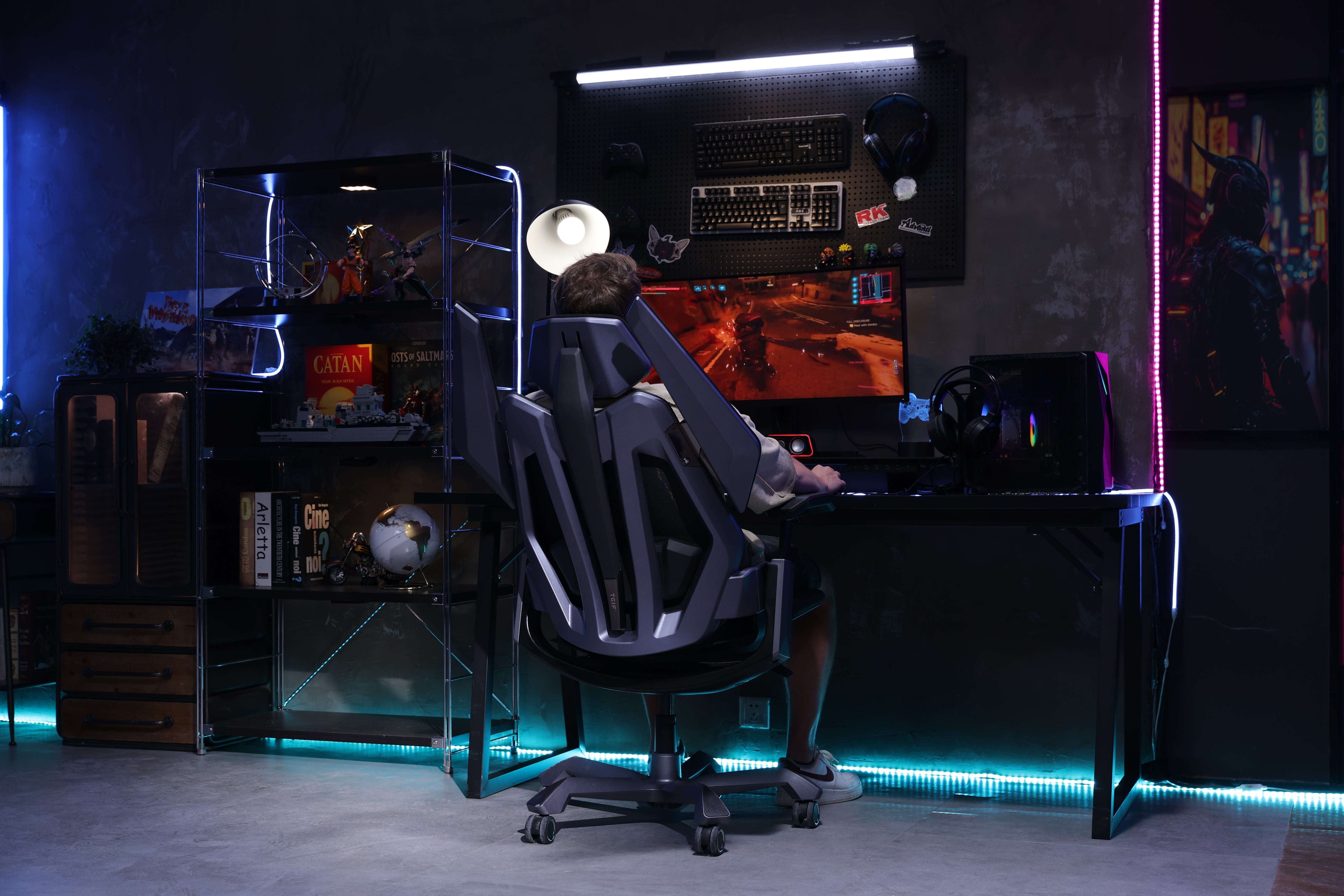 Picture showing the TGIF T0 from the back with a person sitting on it, the chair in lying position and playing video games.